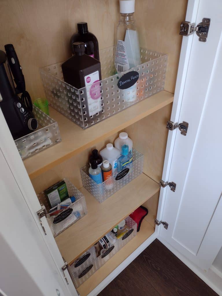 bottom portion of bathroom cabinet for with containers that are labeled