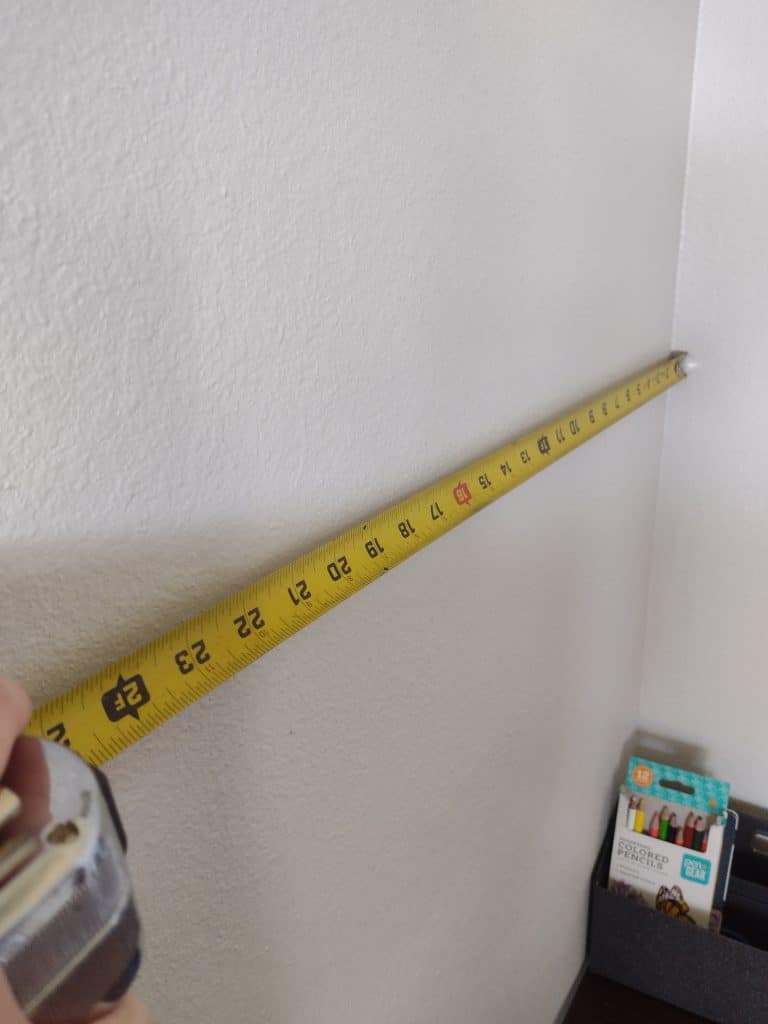 tape measure measuring a wall