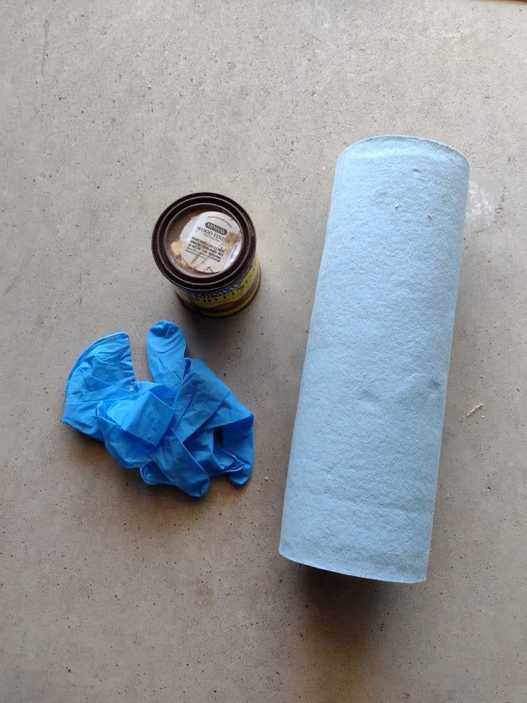 can of stain, gloves and paper towels